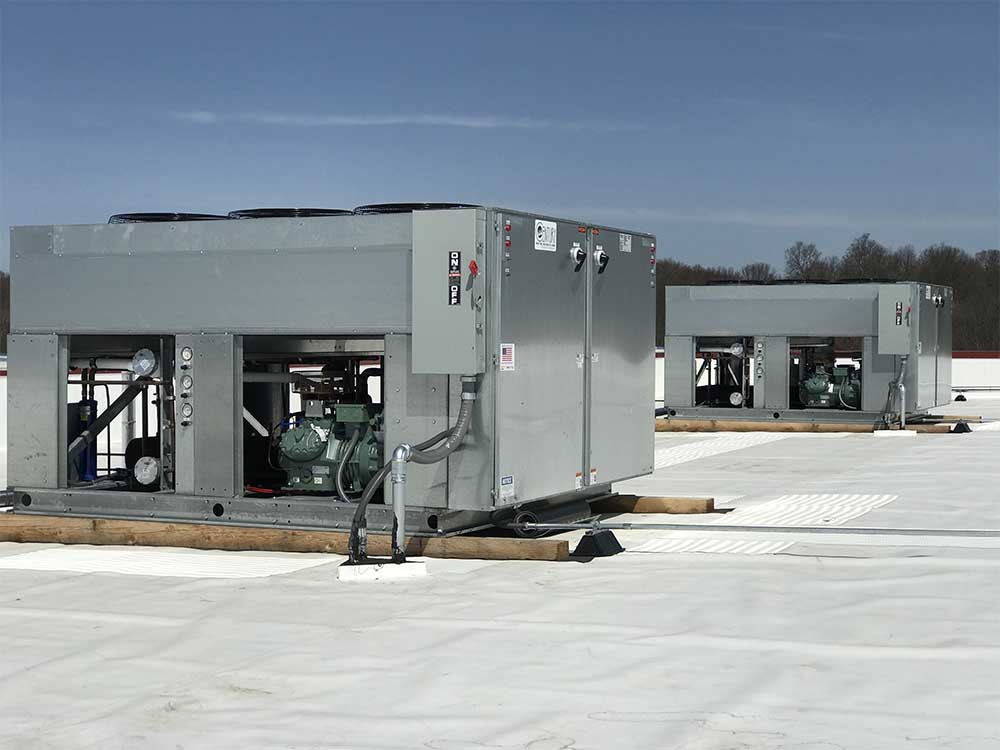 Close up of 2 Refrigeration units on roof of warehouse