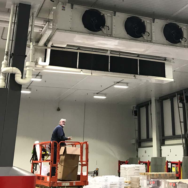 Mullally team member under Refrigeration Unit